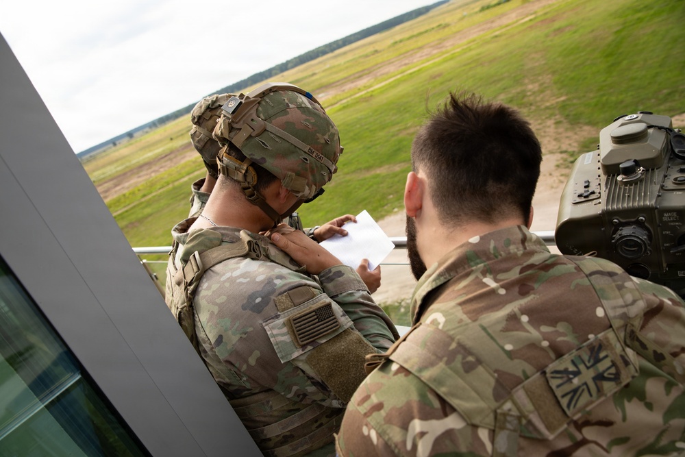 U.S. and British soldiers build interoperability as Paladins fire during range training