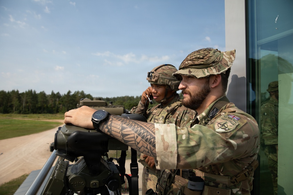 U.S. and British soldiers build interoperability as Paladins fire during range training