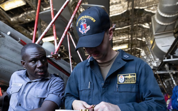 U.S. Navy and RBDF officers load pistol magazines