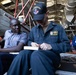 U.S. Navy and RBDF officers load pistol magazines