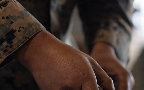 U.S. Marines with 1st LAR prepare for battle carry drills during Coral-Balmoral Cup