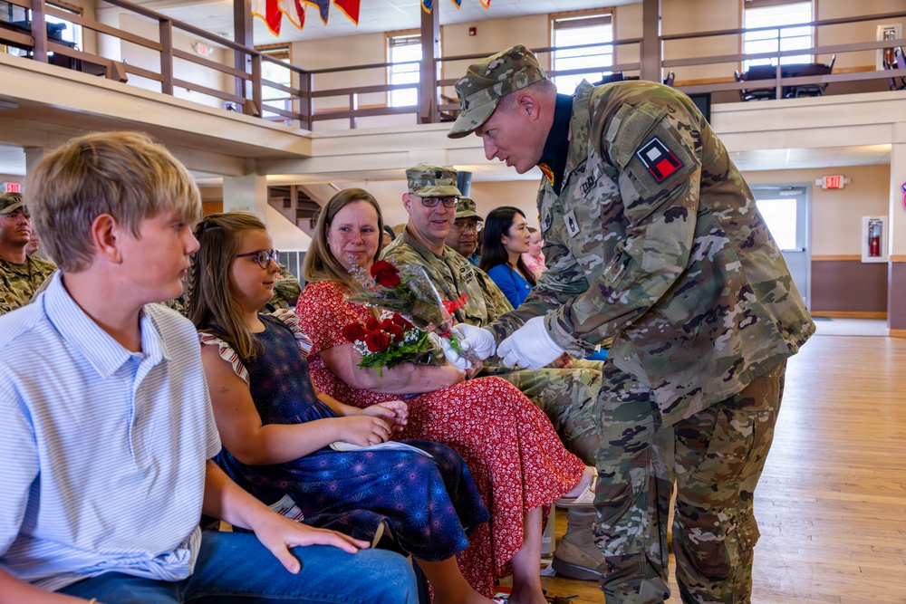 Soldier Hands Red Roses to Family