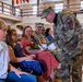 Soldier Hands Red Roses to Family