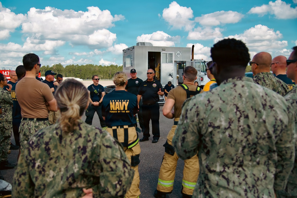 Navy Reserve Commander, Navy Installations Command Fire and Emergency Services Detachment Charlie train using the Mobile Aircraft Fire Trainer Device here at Naval Air Station Jacksonville.