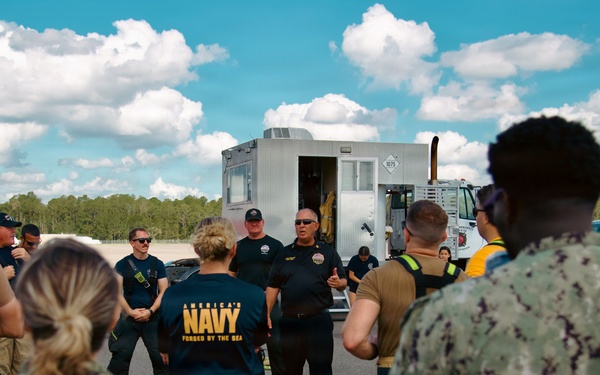 Navy Reserve Commander, Navy Installations Command Fire and Emergency Services Detachment Charlie train using the Mobile Aircraft Fire Trainer Device here at Naval Air Station Jacksonville.