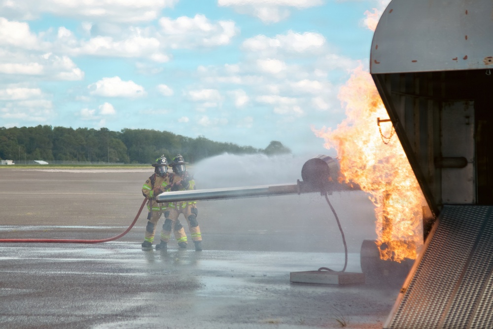 Navy Reserve Commander, Navy Installations Command Fire and Emergency Services Detachment Charlie train using the Mobile Aircraft Fire Trainer Device here at Naval Air Station Jacksonville.