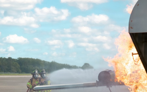 Navy Reserve Commander, Navy Installations Command Fire and Emergency Services Detachment Charlie train using the Mobile Aircraft Fire Trainer Device here at Naval Air Station Jacksonville.