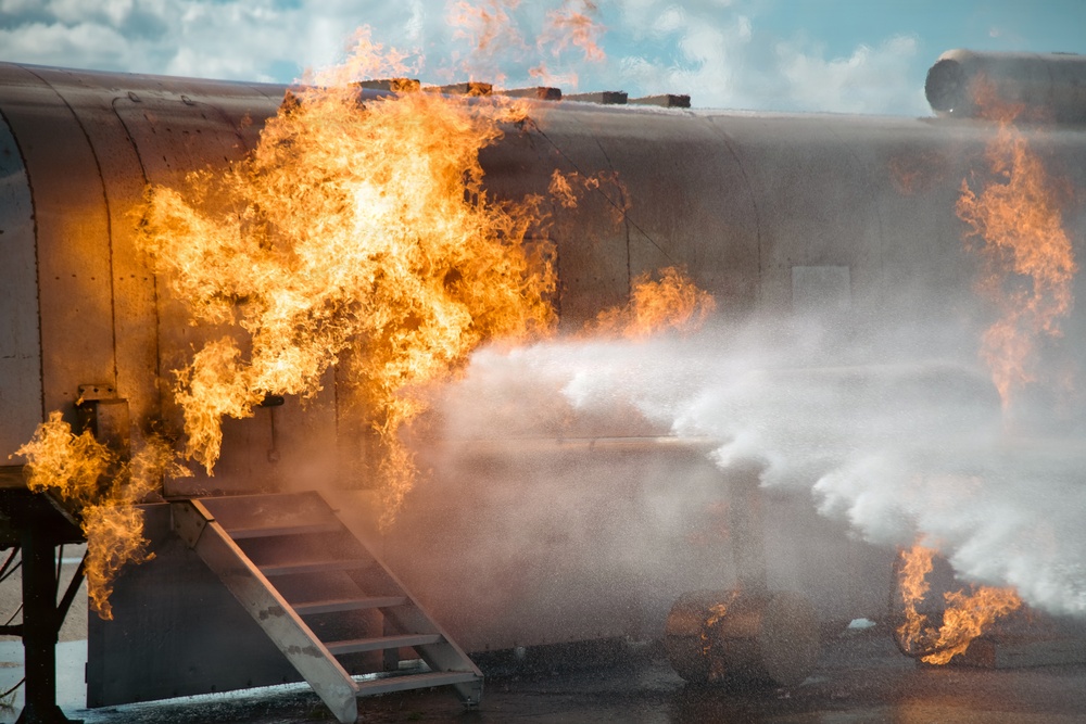 Navy Reserve Commander, Navy Installations Command Fire and Emergency Services Detachment Charlie train using the Mobile Aircraft Fire Trainer Device here at Naval Air Station Jacksonville.