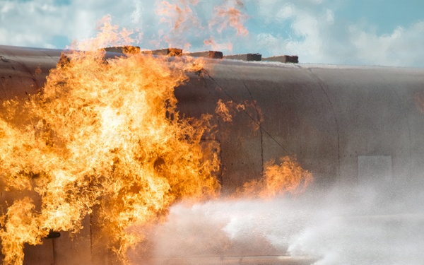 Navy Reserve Commander, Navy Installations Command Fire and Emergency Services Detachment Charlie train using the Mobile Aircraft Fire Trainer Device here at Naval Air Station Jacksonville.