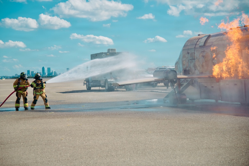 Navy Reserve Commander, Navy Installations Command Fire and Emergency Services Detachment Charlie train using the Mobile Aircraft Fire Trainer Device here at Naval Air Station Jacksonville.