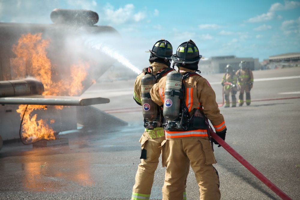 Navy Reserve Commander, Navy Installations Command Fire and Emergency Services Detachment Charlie train using the Mobile Aircraft Fire Trainer Device here at Naval Air Station Jacksonville.
