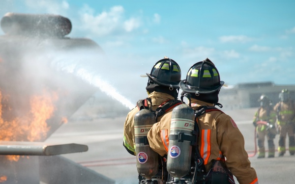 Navy Reserve Commander, Navy Installations Command Fire and Emergency Services Detachment Charlie train using the Mobile Aircraft Fire Trainer Device here at Naval Air Station Jacksonville.