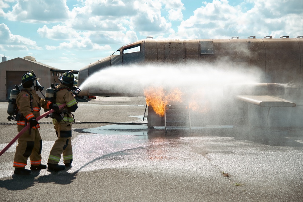 Navy Reserve Commander, Navy Installations Command Fire and Emergency Services Detachment Charlie train using the Mobile Aircraft Fire Trainer Device here at Naval Air Station Jacksonville.