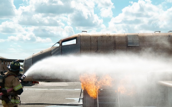 Navy Reserve Commander, Navy Installations Command Fire and Emergency Services Detachment Charlie train using the Mobile Aircraft Fire Trainer Device here at Naval Air Station Jacksonville.