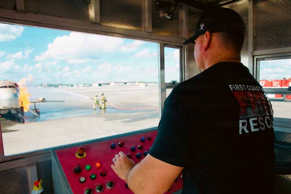 Navy Reserve Commander, Navy Installations Command Fire and Emergency Services Detachment Charlie train using the Mobile Aircraft Fire Trainer Device here at Naval Air Station Jacksonville.