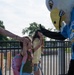 Airmen and civilians cheer students on their first day of school