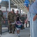 Airmen and civilians cheer students on their first day of school