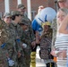 Airmen and civilians cheer students on their first day of school