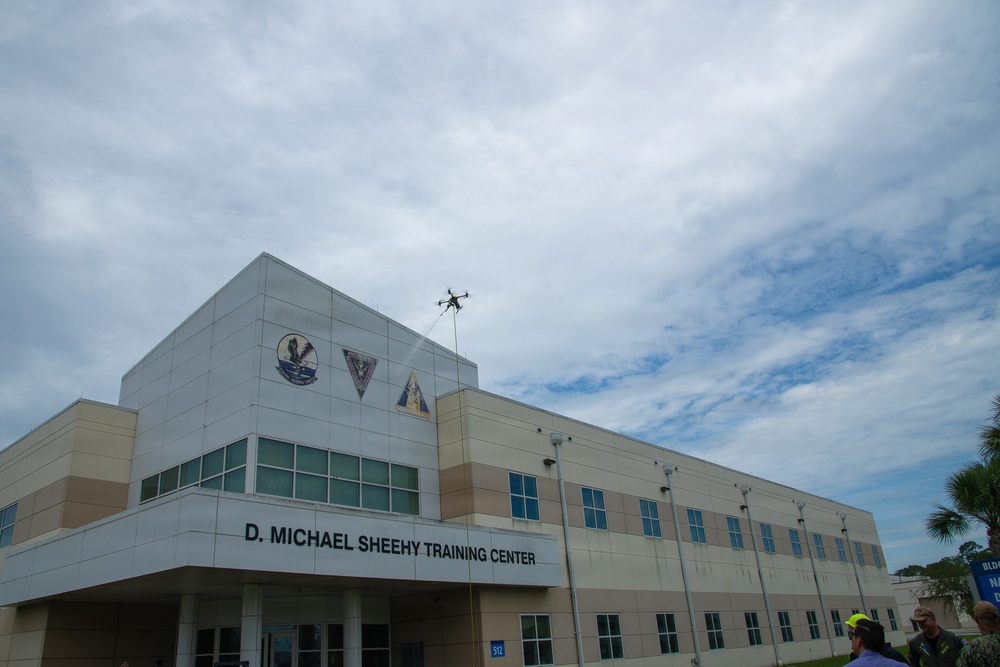 Demonstration of an Apellix B2 pressure washing drone to Naval Air Station Jacksonville leadership
