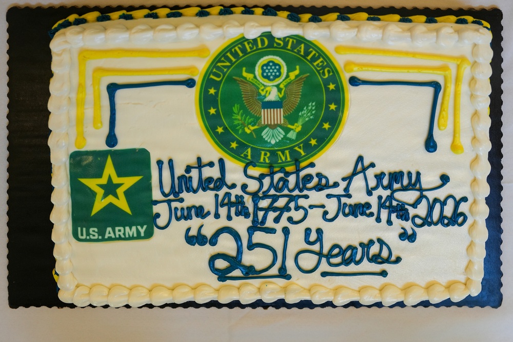 A rectangular sheet cake celebrating the 251st anniversary of the United States Army. The cake features white frosting decorated with blue and yellow piping, the official U.S. Army seal, the Army star logo, and inscribed text marking the founding date of June 14th, 1775 through June 14th, 2026.