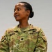 A U.S. Army soldier wearing Operational Camouflage Pattern (OCP) uniform is photographed against a neutral gray background. The name tape reads 'GEORGE' and the rank insignia on the chest indicates the rank of Major (O-4), identified by the black oak leaf cluster. A medical corps branch insignia is visible on the right chest area.