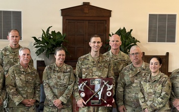 Logistics Officer Receives Blackhawks Double Tomahawks Plaque
