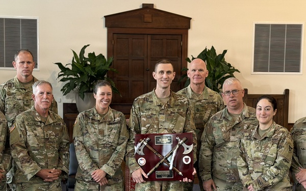 Logistics Officer Receives Blackhawks Double Tomahawks Plaque