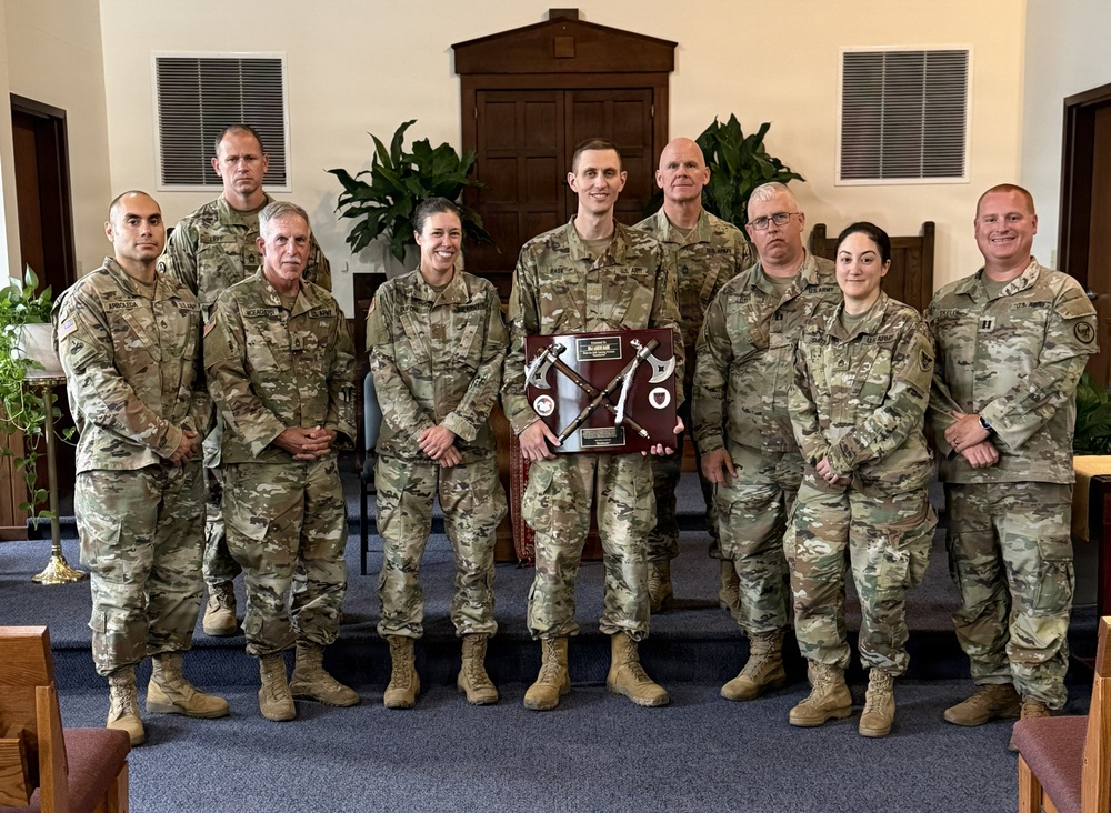 Logistics Officer Receives Blackhawks Double Tomahawks Plaque