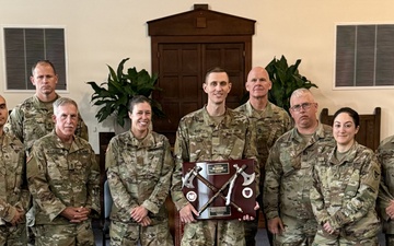 Logistics Officer Receives Blackhawks Double Tomahawks Plaque