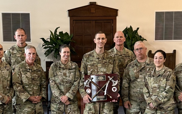 Logistics Officer Receives Blackhawks Double Tomahawks Plaque