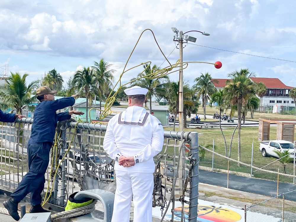 Sailor throws line during ships mooring
