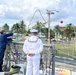 Sailor throws line during ships mooring