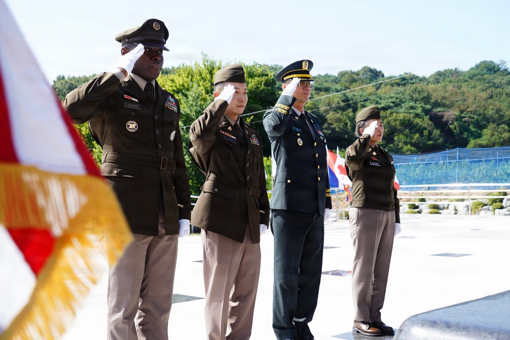 Allied Soldiers salute the fallen at Hill 303