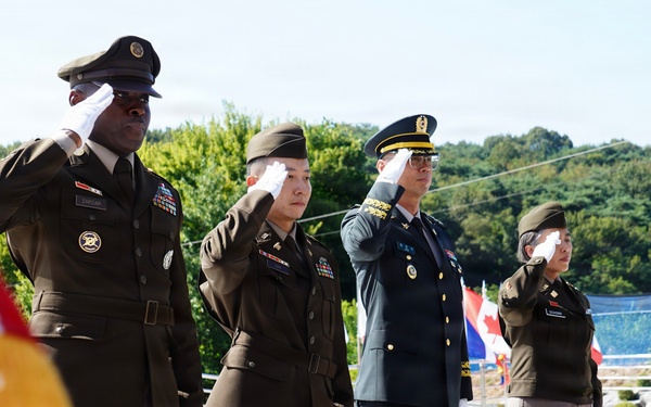 Allied Soldiers salute the fallen at Hill 303