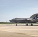 A U.S. Marines F-35B stealth fighter jet is parked on a tarmac near a hangar structure. The aircraft belongs to VMFA-231 squadron, featuring distinctive special livery with spade card suit markings, 'CG' initials, and the number 19 on the tail. Ground crew personnel are visible near the aircraft in what appears to be a ceremonial or commemorative display setting.
