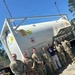 U.S. Air Force Airmen assigned to the 23d Logistics Readiness Squadron pose for a photo in front of an intermodal International Organization of Standardization liquid oxygen tank