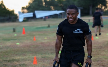 Cpt. Brown carries kettlebells during Army Fitness Test