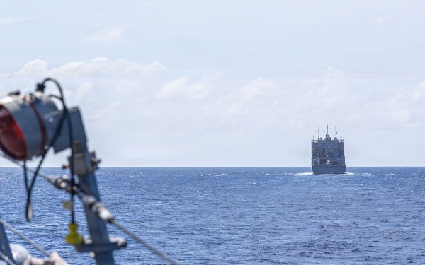 USS Mustin conducts a replenishment-at-sea with USNS Wally Schirra
