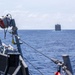 USS Mustin conducts a replenishment-at-sea with USNS Wally Schirra