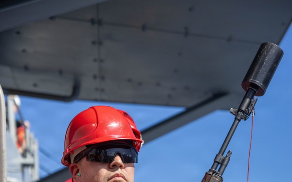 USS Mustin conducts a replenishment-at-sea with USNS Wally Schirra