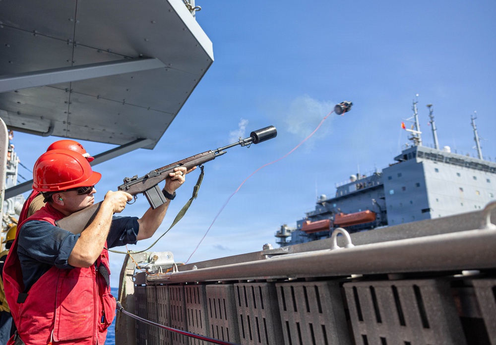 USS Mustin conducts a replenishment-at-sea with USNS Wally Schirra