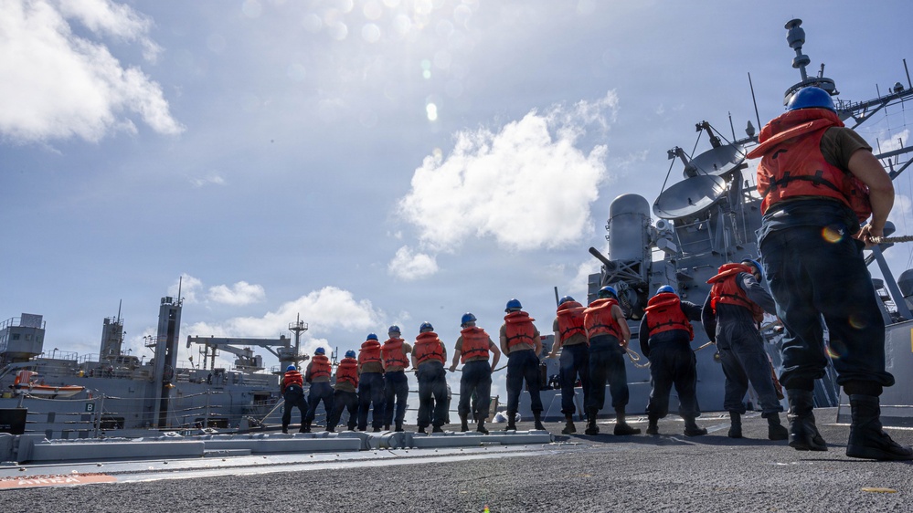 USS Mustin conducts a replenishment-at-sea with USNS Wally Schirra