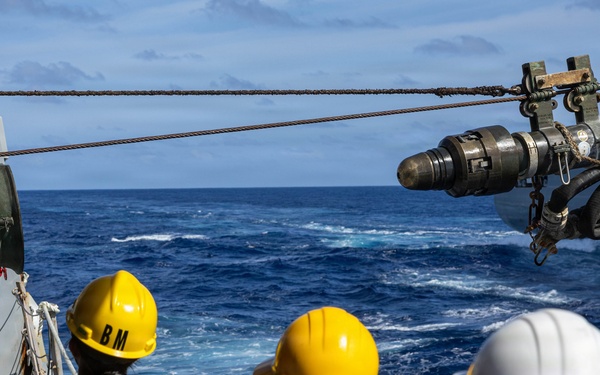 USS Mustin conducts a replenishment-at-sea with USNS Wally Schirra