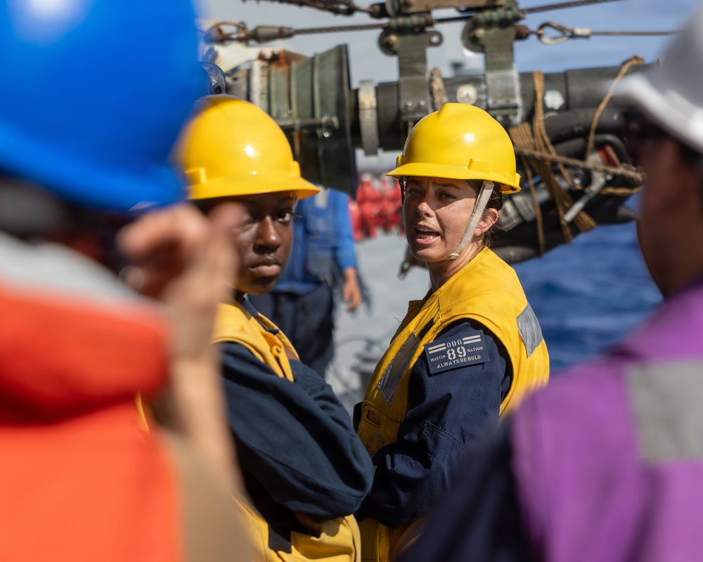 USS Mustin conducts a replenishment-at-sea with USNS Wally Schirra