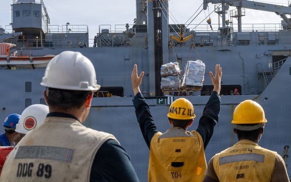 USS Mustin conducts a replenishment-at-sea with USNS Wally Schirra