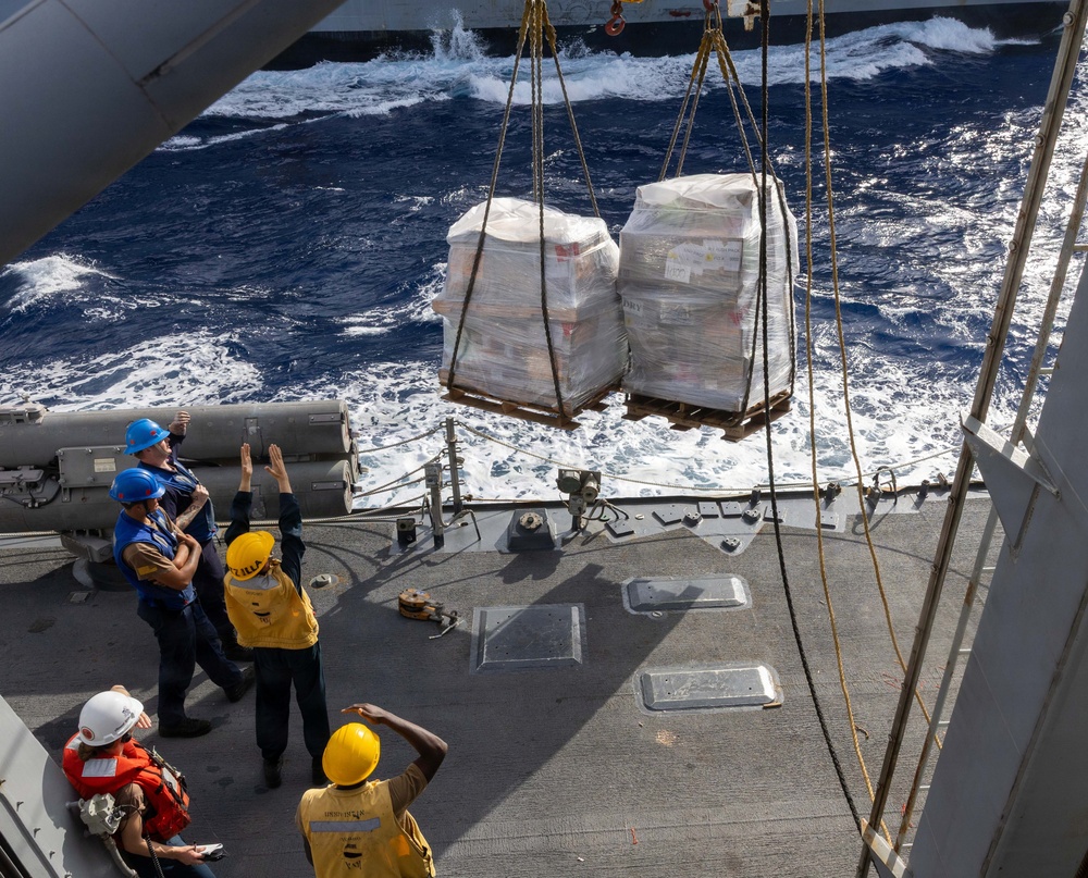 USS Mustin conducts a replenishment-at-sea with USNS Wally Schirra