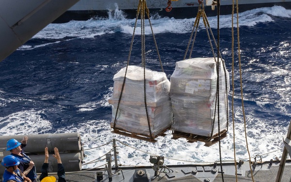 USS Mustin conducts a replenishment-at-sea with USNS Wally Schirra