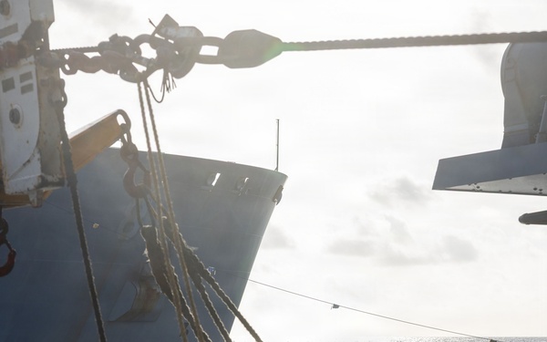 USS Mustin conducts a replenishment-at-sea with USNS Wally Schirra
