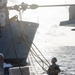 USS Mustin conducts a replenishment-at-sea with USNS Wally Schirra
