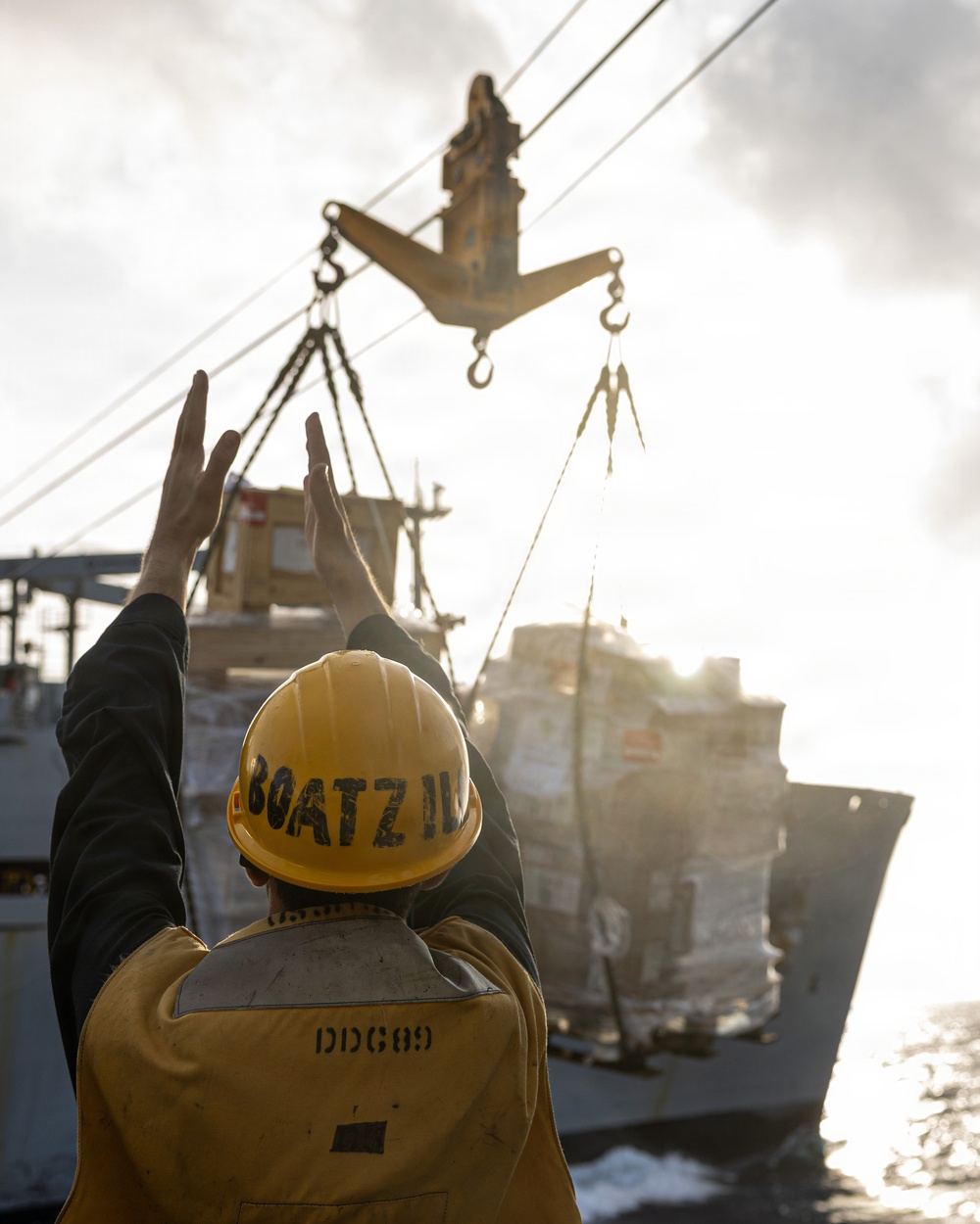 USS Mustin conducts a replenishment-at-sea with USNS Wally Schirra